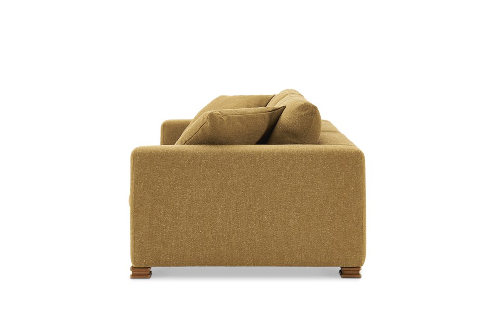 Side profile of the Kagan sofa with thick cushioned arm and carved oak pillar