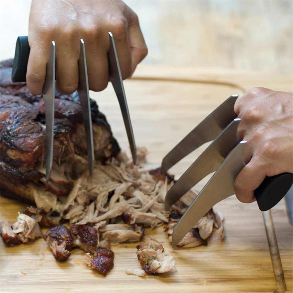 BBQ meat shredder claws lifting and separating tender cooked meat