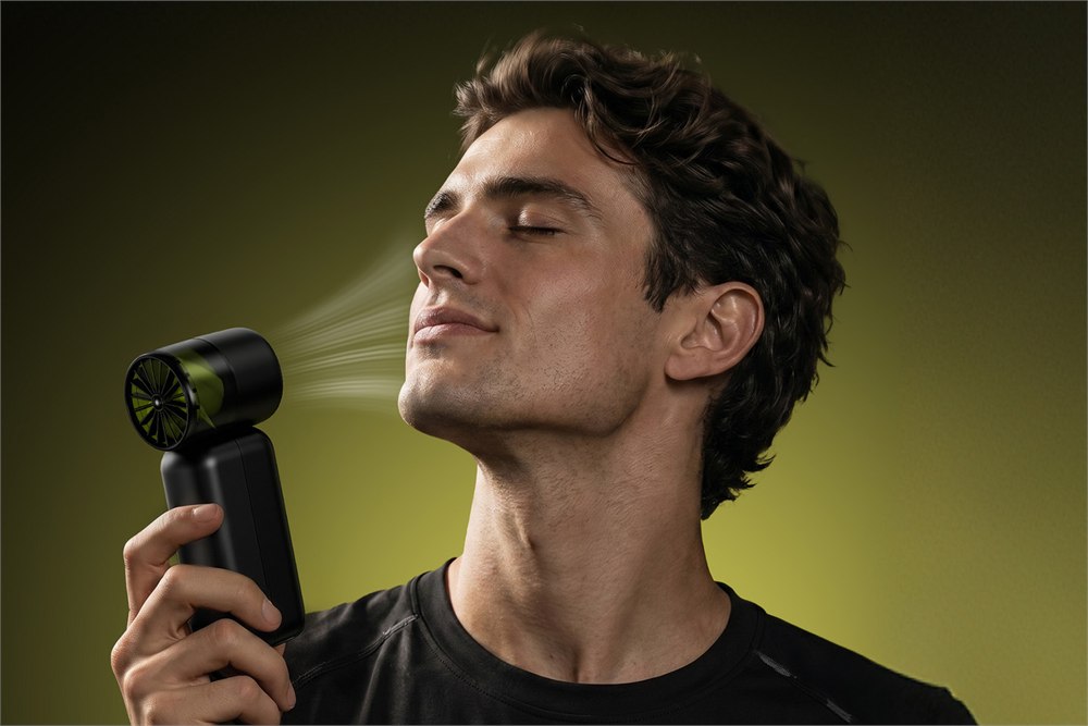 MOVESPEED ChillVolt handheld cooling fan blowing air toward a person