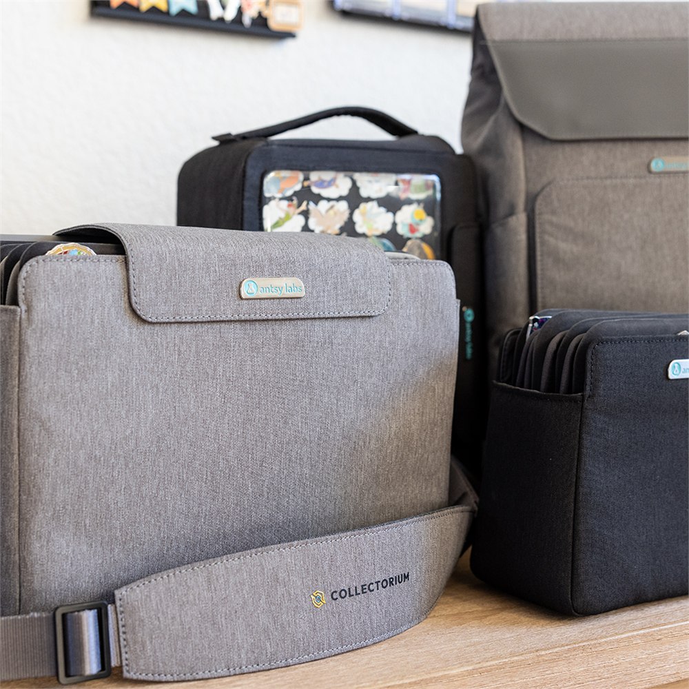 Collectorium modular lineup with backpack, vault, binders, boards, and display pieces