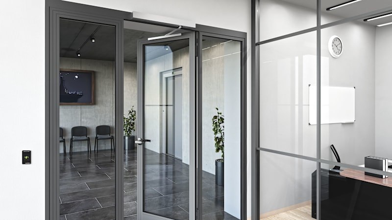 dormakaba EasyAssist mounted above a modern interior glass door