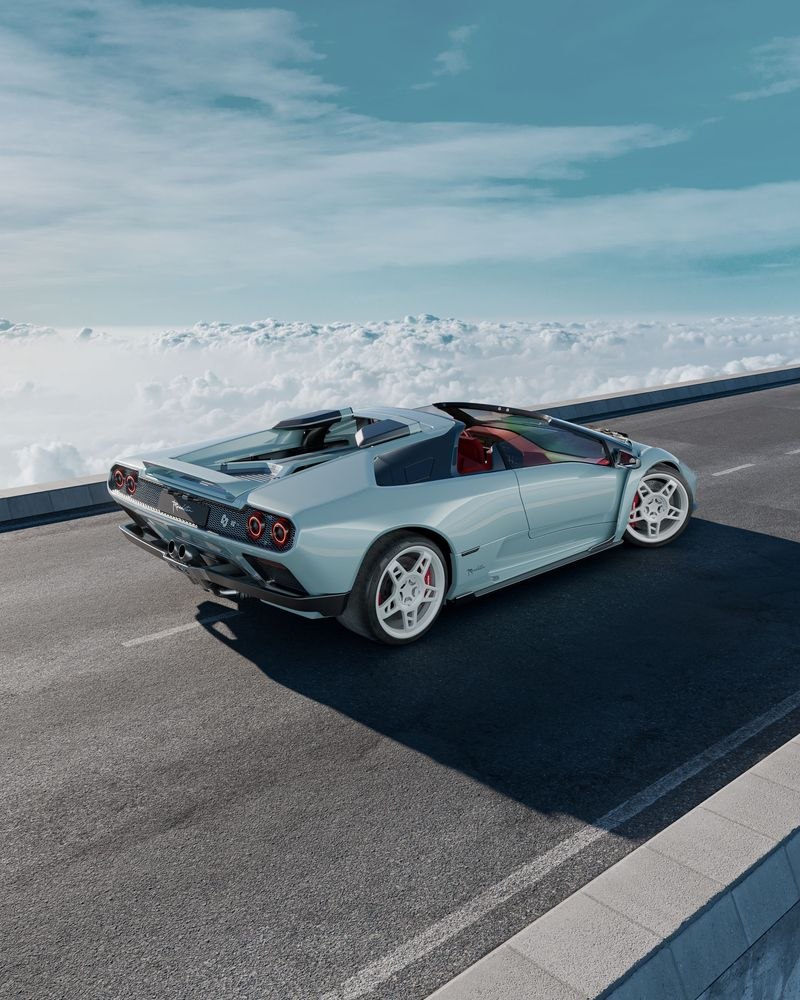 Eccentrica V12 Roadster shown from the rear on a mountain road