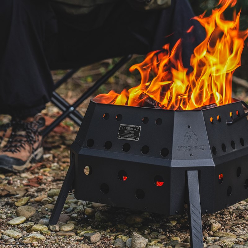 Close-up of the black hexagonal FIRE PIT MAX fire pit with flames inside
