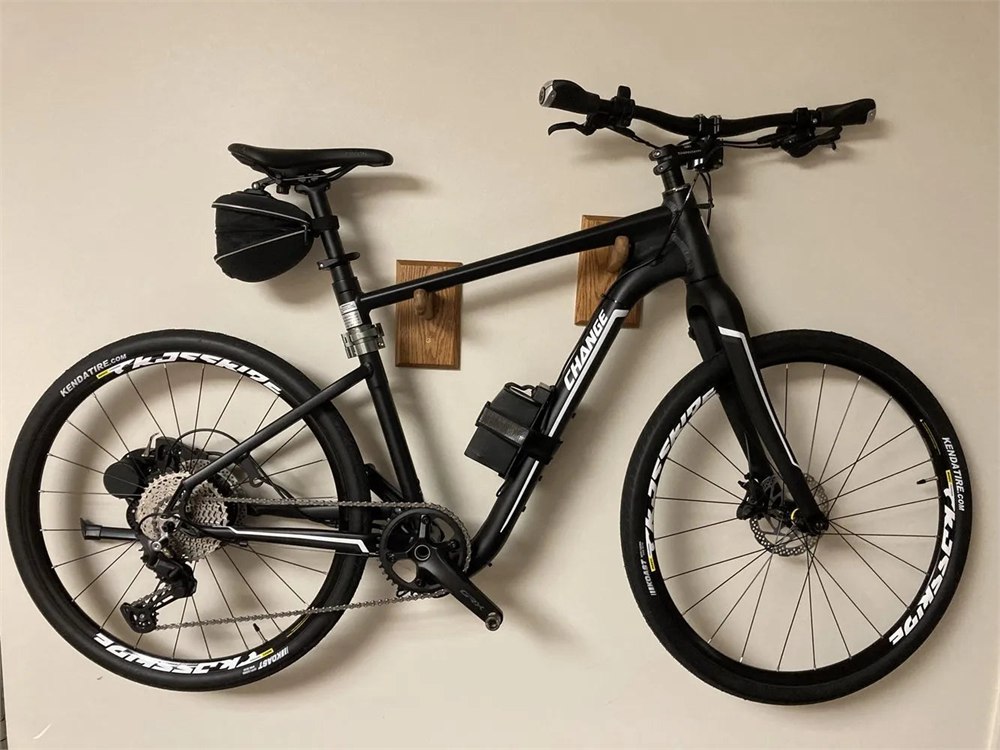 Full-size bicycle stored close against a wall with Flatbike components