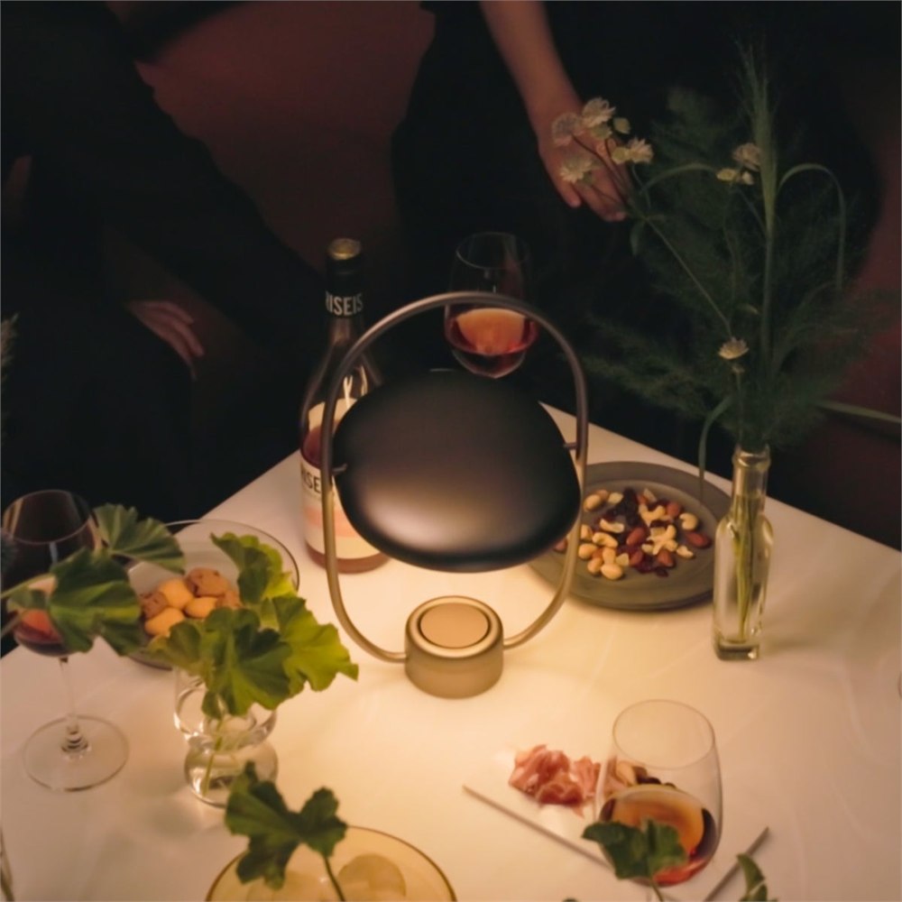 Luminous mirror diffuser glowing on a dinner table