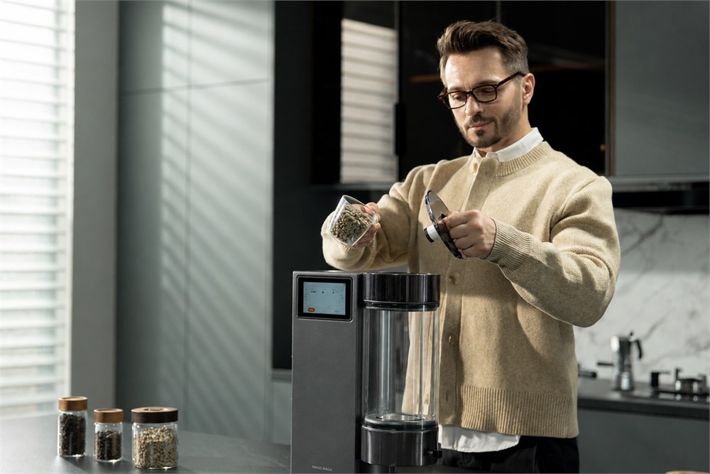 Coffee beans being poured into the Roma-X transparent roasting chamber
