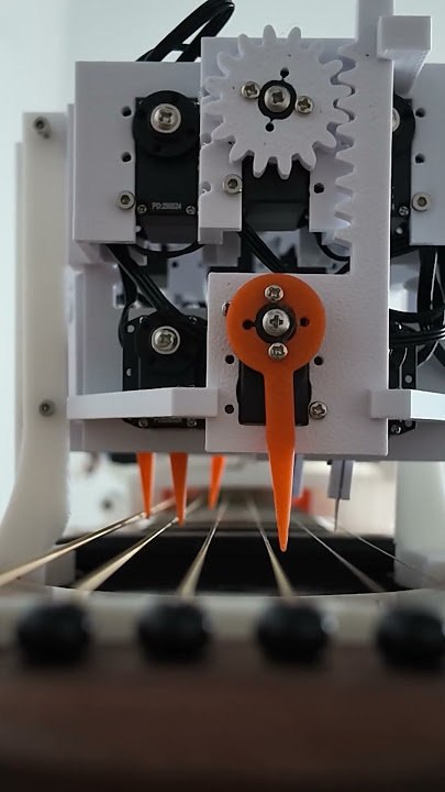 Close-up of the MegCell Pulse plucking mechanism near the guitar strings