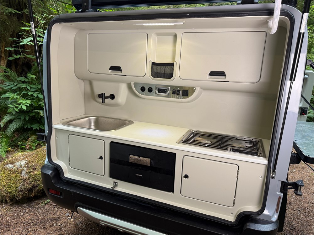 Motsmann Outranger rear galley with sink, cooktop, refrigerator, and storage