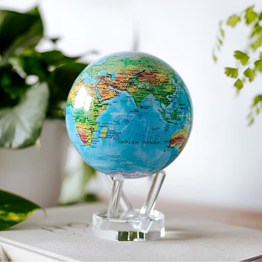 Close view of the bright blue raised relief map on the MOVA globe