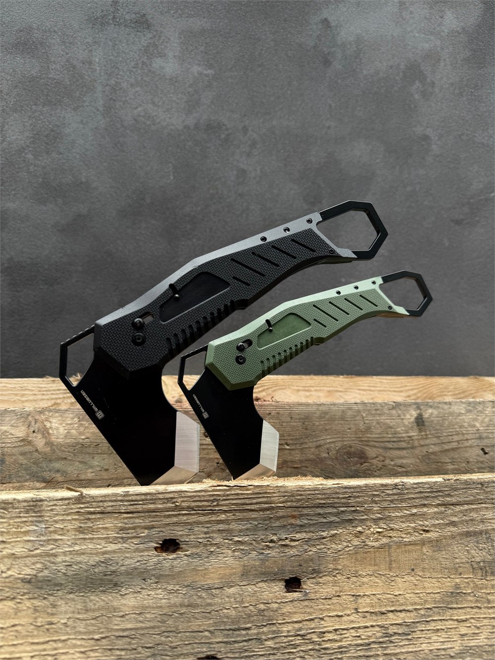 The green and black Willumsen Norse Foldable camp axe versions on wood