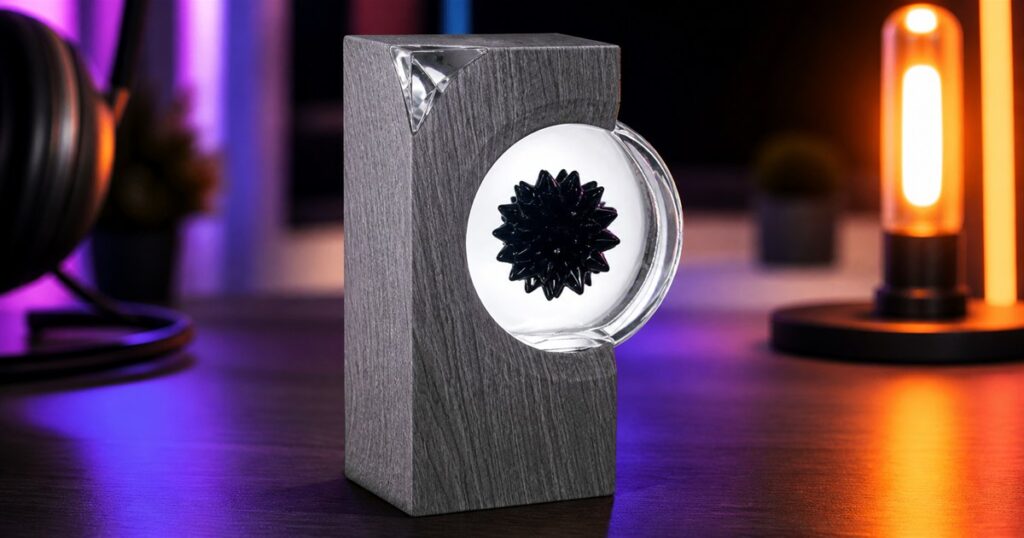 A no-text generated product image of a gray ferrofluid sound visualizer on a desktop.