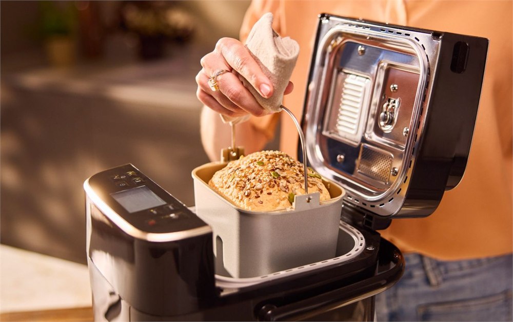Panasonic SD-PMC100 open bread maker with baked loaf in the pan