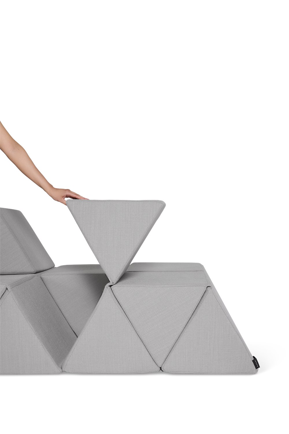 Hand folding one triangular backrest on the Moooi Peaks modular sofa