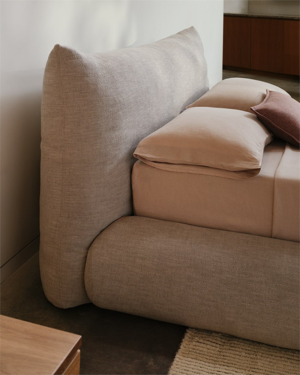 Knoll Perron Pillo Bed shown in a styled room with upholstered headboard and frame