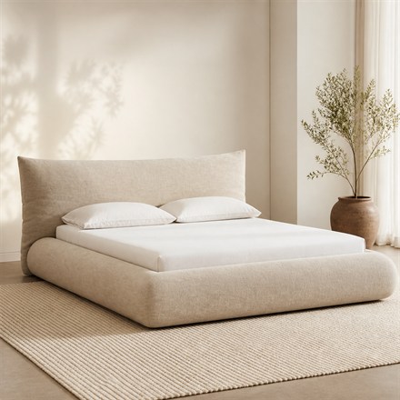 This Plush Upholstered Bed Wraps Your Mattress In a Giant Pillow Frame