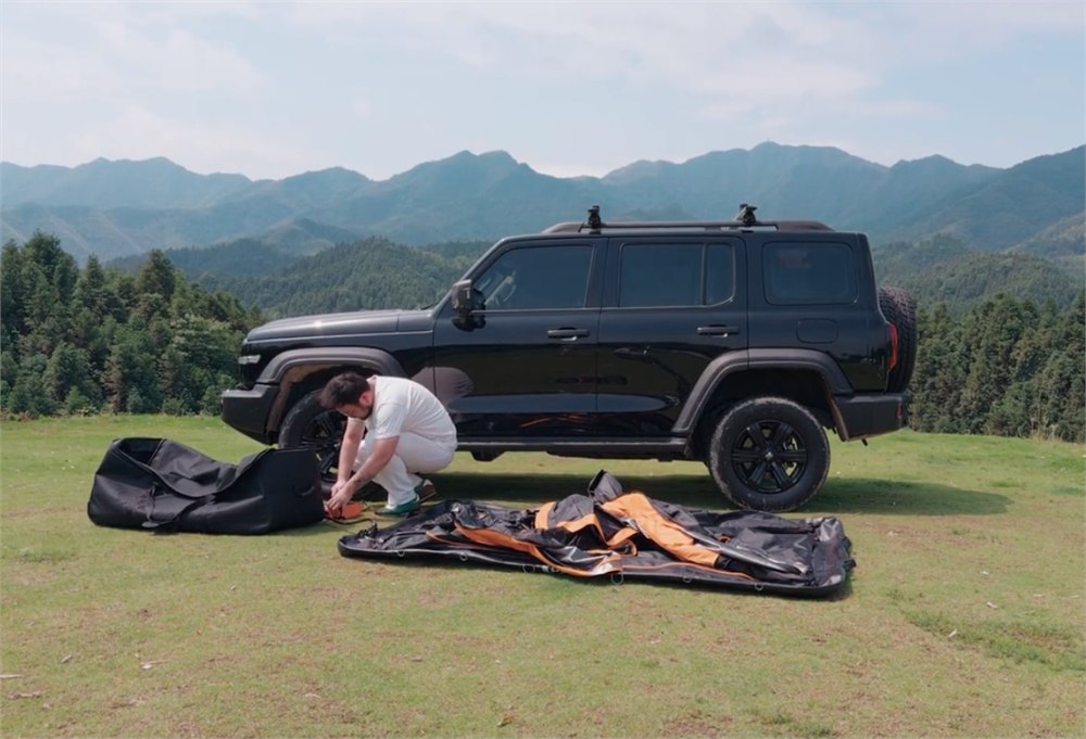 Portal Nomis One tent being unpacked beside an SUV