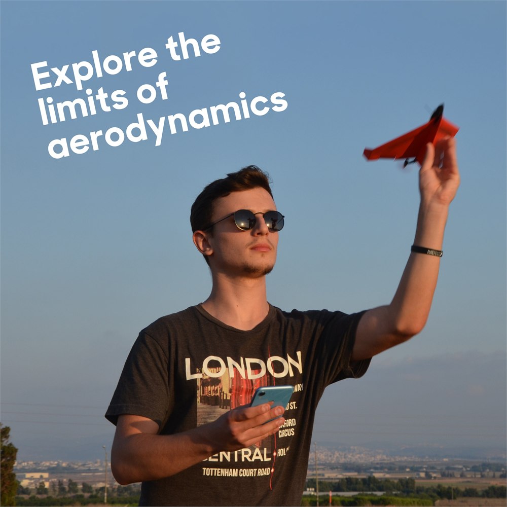 POWERUP 4.0 paper airplane being launched outdoors with smartphone control