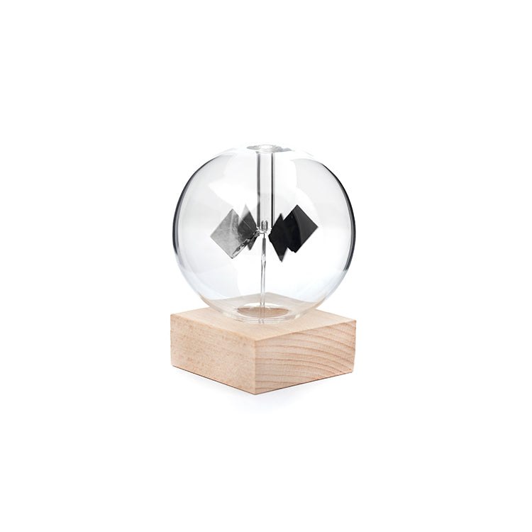 Kikkerland Solar Radiometer studio view with clear glass bulb and wood base