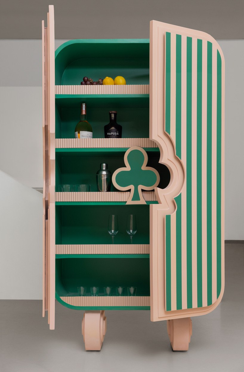 Open Ramino cabinet showing green shelves and curved striped doors