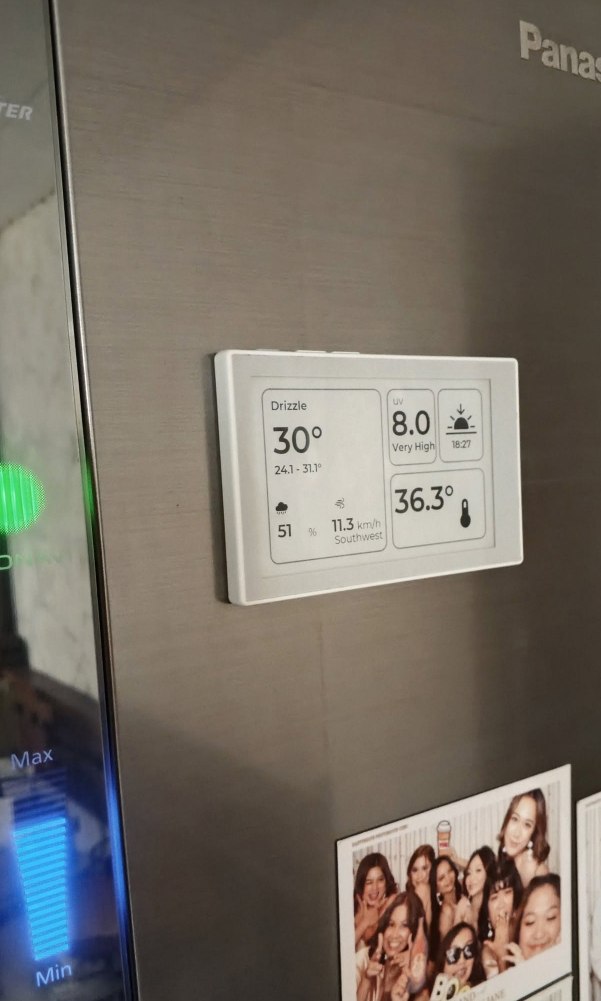 reTerminal Sticky showing a weather panel on a refrigerator