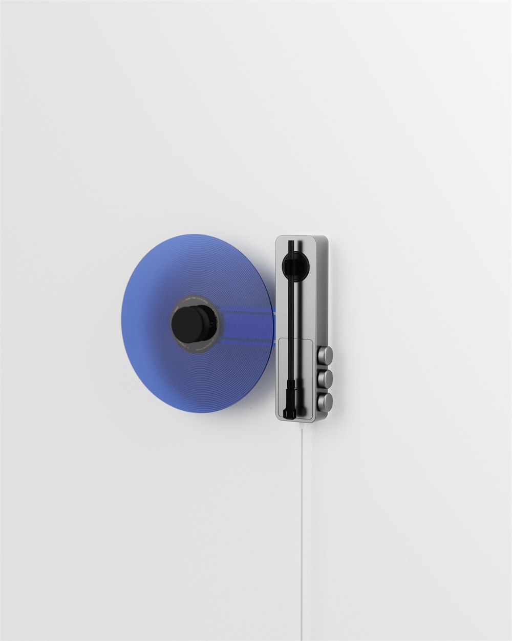 Ruka TD-1 vertical turntable with blue vinyl record and magnetic center clamp