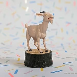 Close-up of the screaming goat figurine standing on its tree-stump base