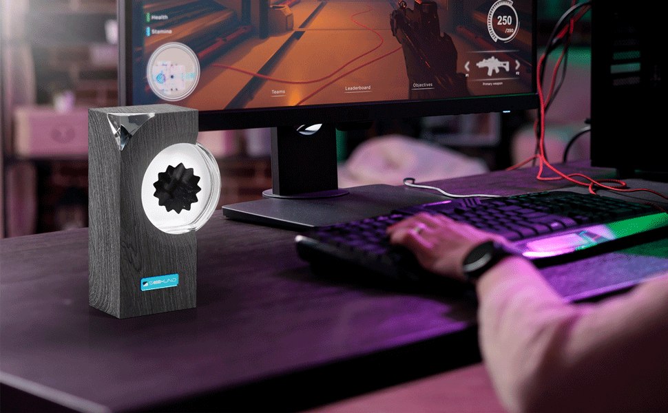 The ferrofluid sound visualizer shown beside a gaming keyboard and monitor setup.