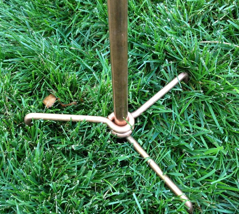 Four point copper ground anchor at the base of the wind sculpture pole
