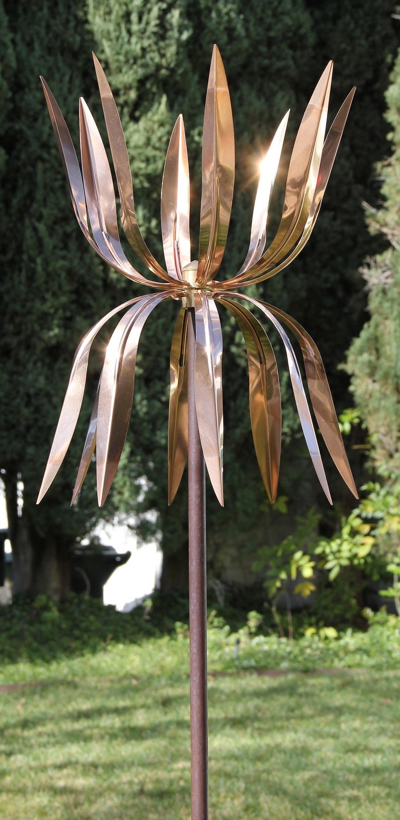 Full view of the copper Dancing Octopus wind sculpture on its pole