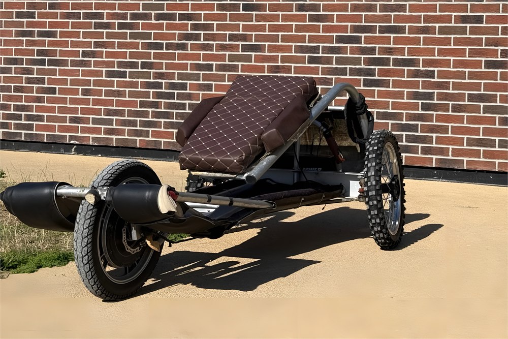Side view of a Sweren Swerv prone trike showing frame and front wheel details