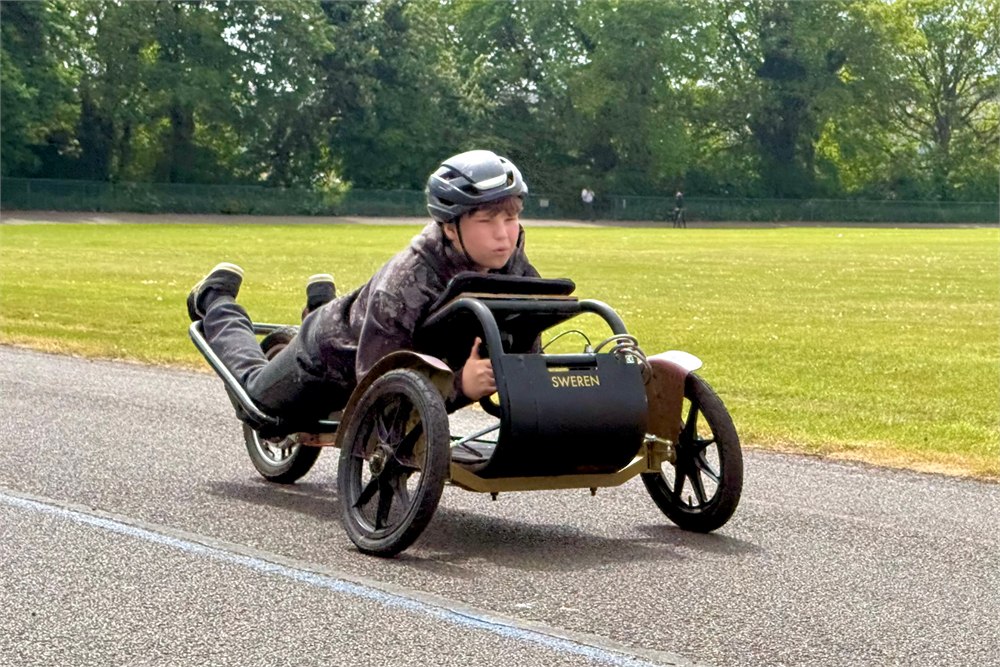 Road legal Sweren Swerv prone electric trike being ridden on pavement