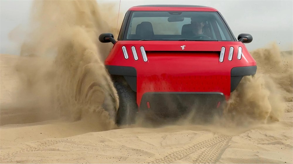 TELO MT1 electric mini truck driving through sand