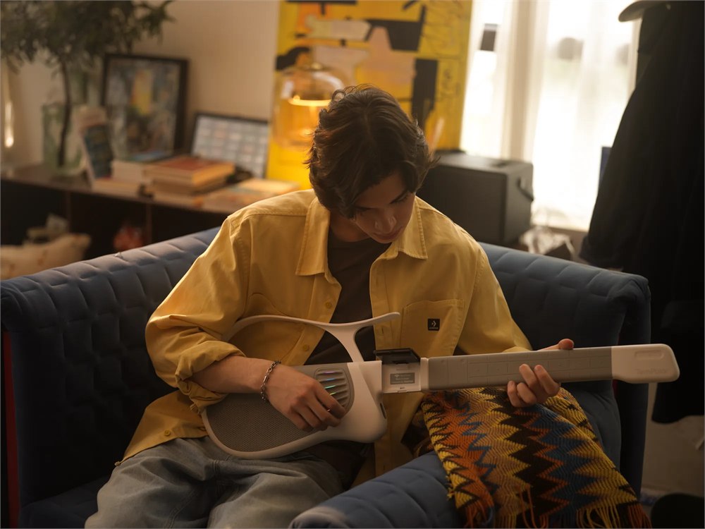 Person playing the TemPolor Melo-D AI Guitar at home