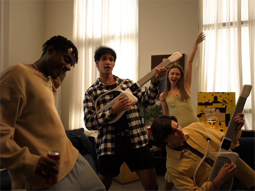 Friends using TemPolor Melo-D guitars during a casual home jam