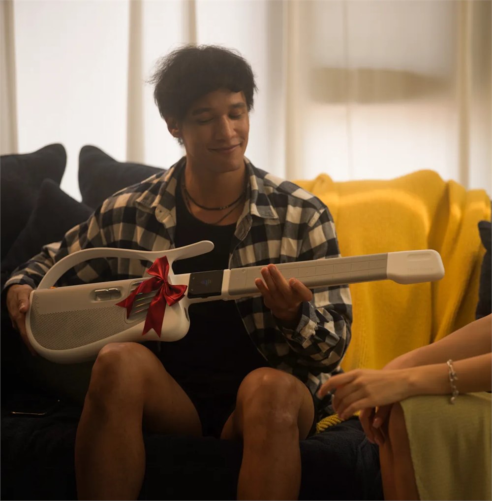 TemPolor Melo-D AI Guitar being unwrapped as a gift