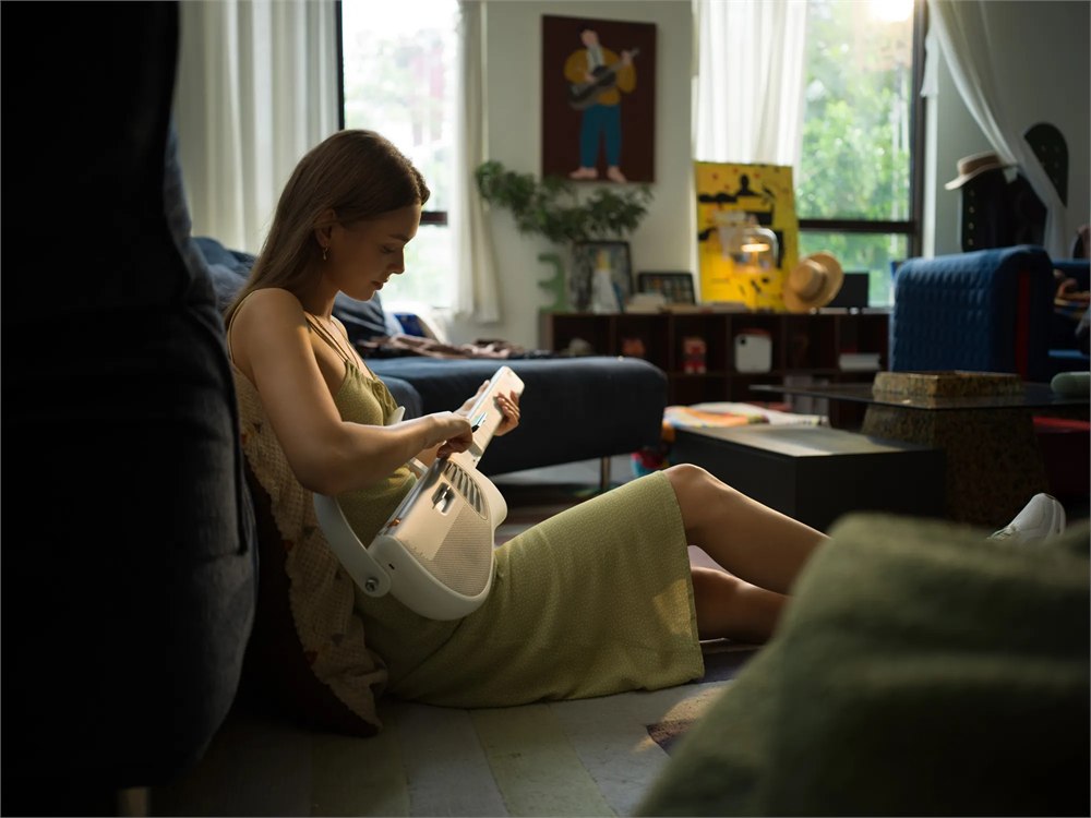 Person practicing with the TemPolor Melo-D foldable guitar in a living room