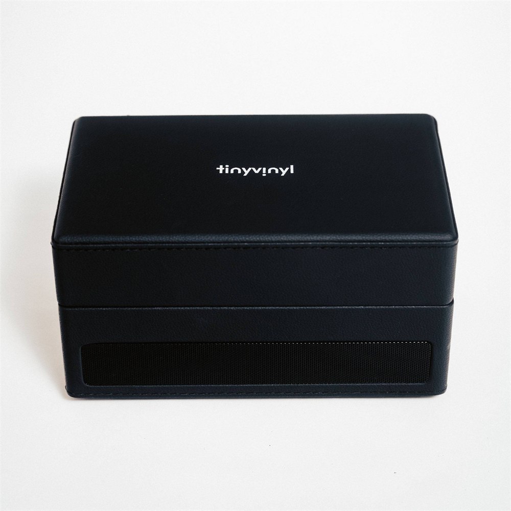 Tiny Vinyl Player shown with the lid open and its compact storage area visible
