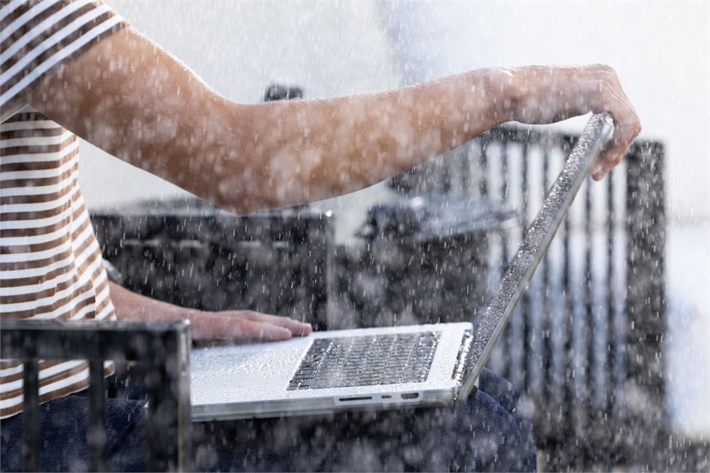Laptop being handled in rain before going into the DRYOUT sleeve