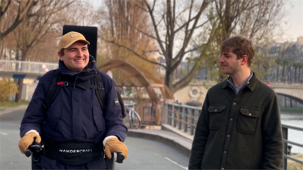 Wandercraft Eve personal exoskeleton user walking with companion