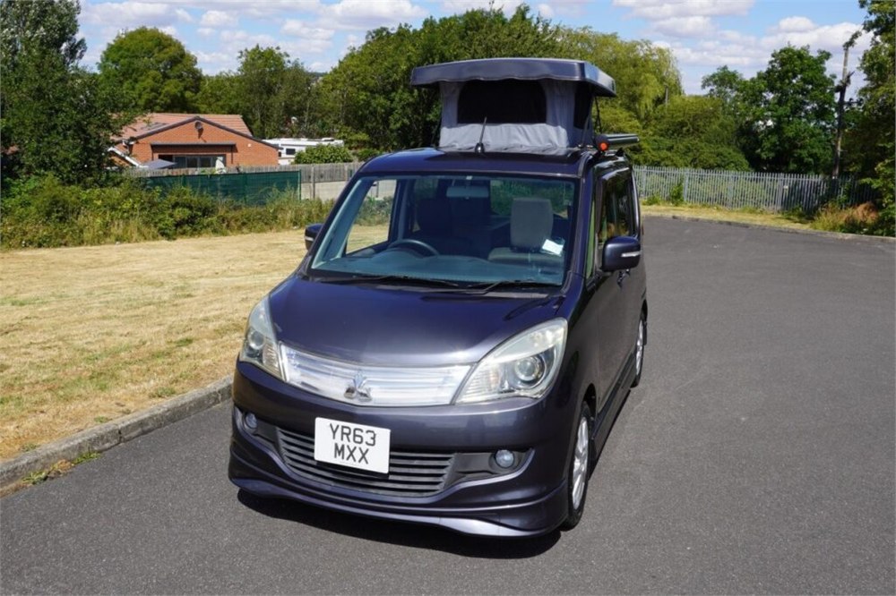 Wellhouse micro camper side view with compact van body