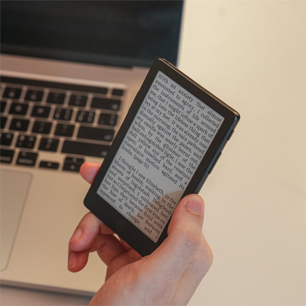 Xteink X4 Pro held in one hand for pocket scale