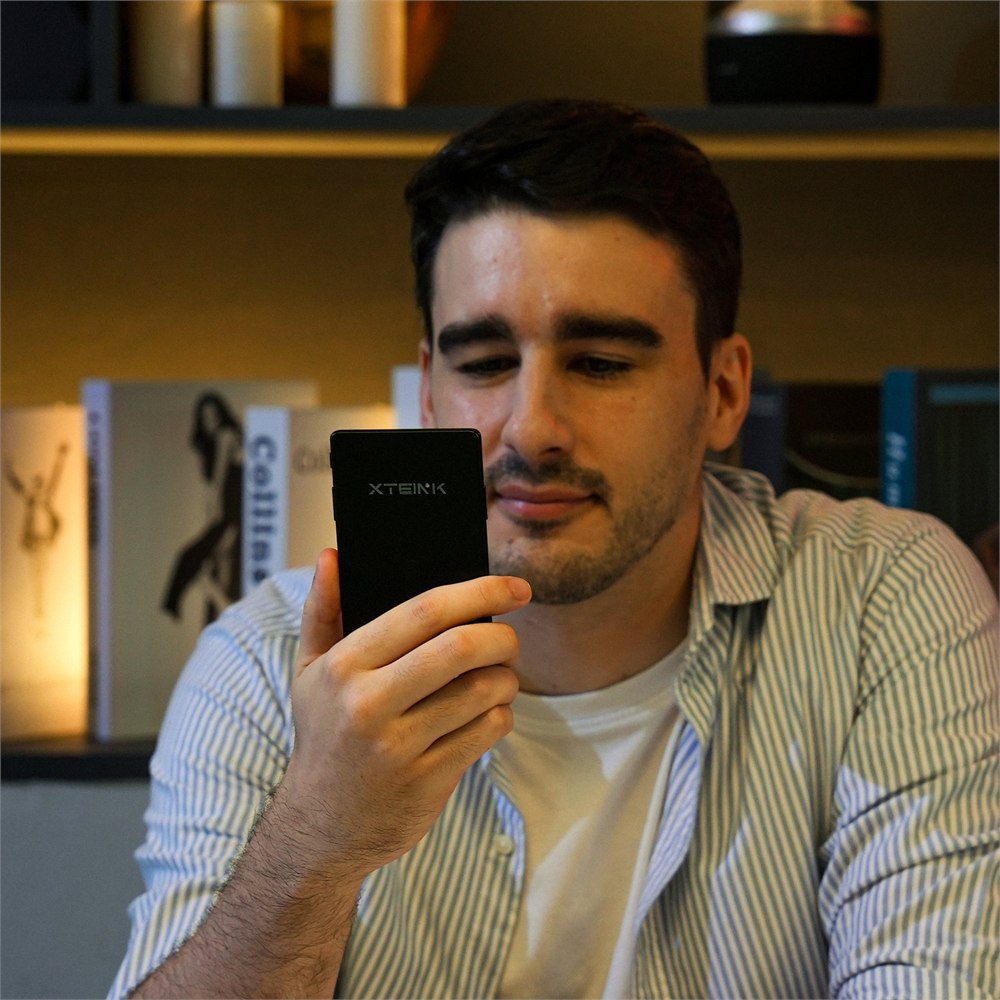 Person reading on the Xteink X4 Pro eReader