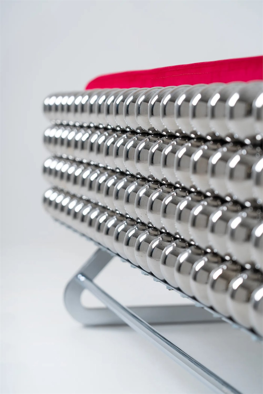 Polished spherical modules on the Wishes Collection furniture with red upholstery