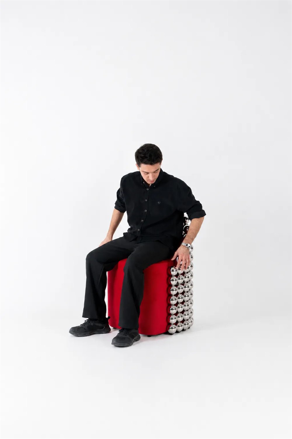 Wishes Collection sculptural red chair with rows of chrome sphere modules