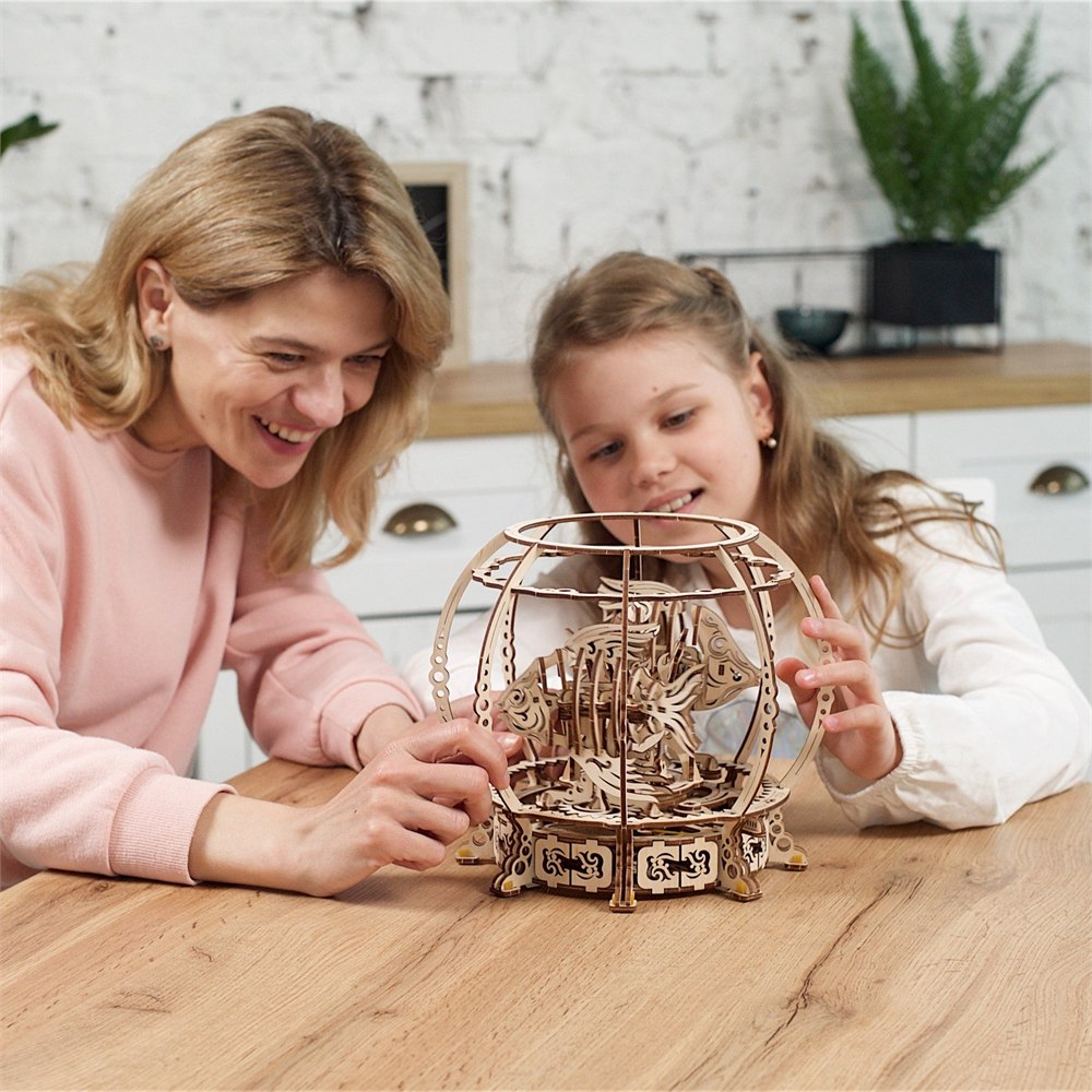 Family looking at the assembled wooden aquarium