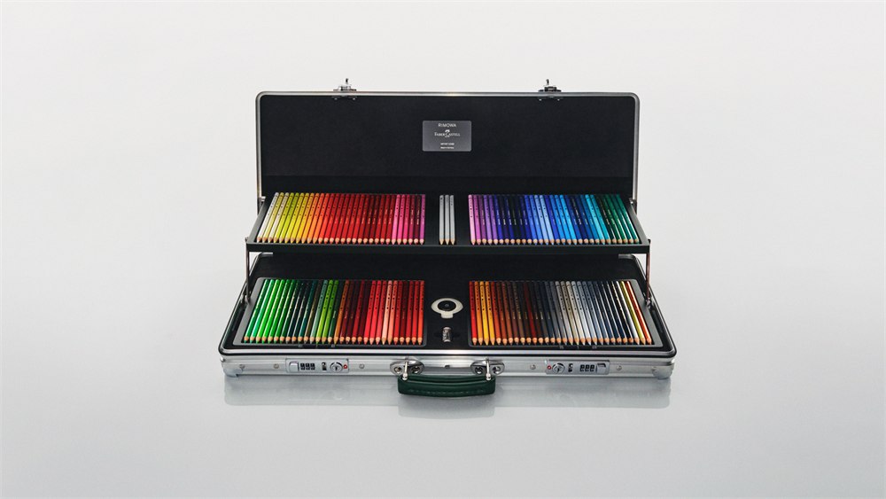 Open aluminum artist case with two tiers of colored pencils