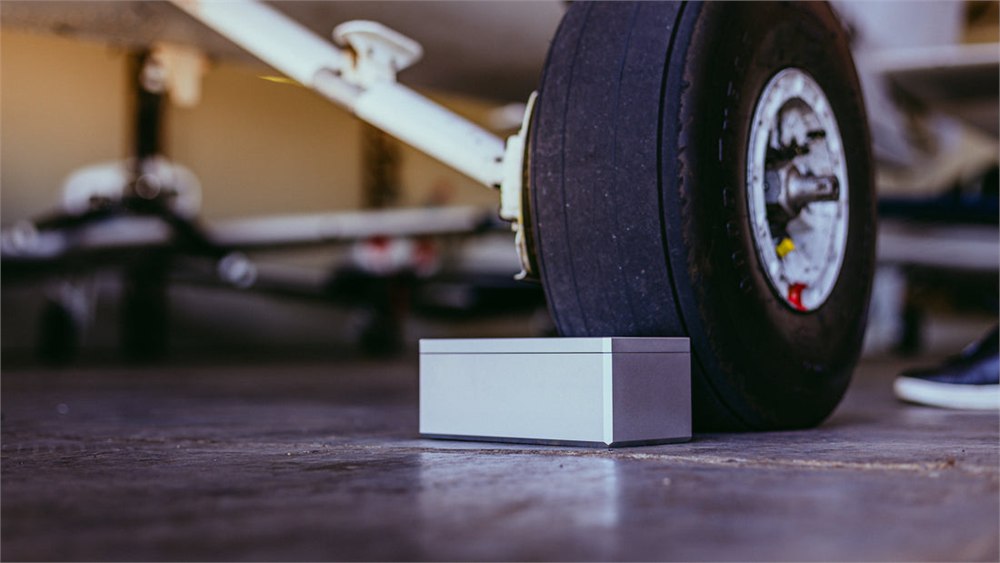 Aerohart Chock Box beside an aircraft wheel in a hangar