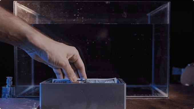 Open aluminum Chock Box with stored dollar bills