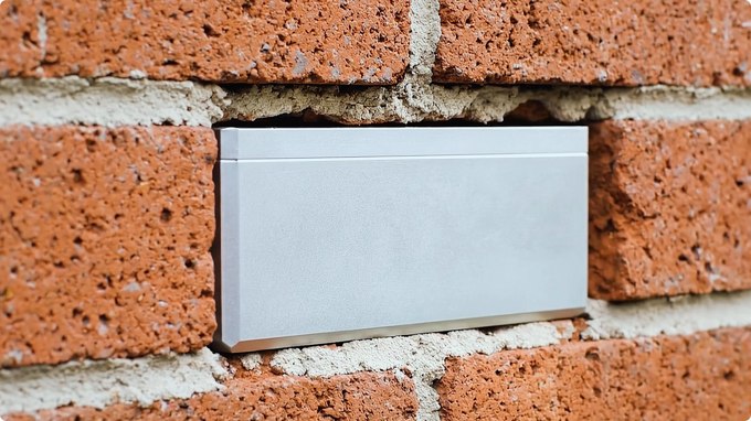 Silver Chock Box placed against a brick wall