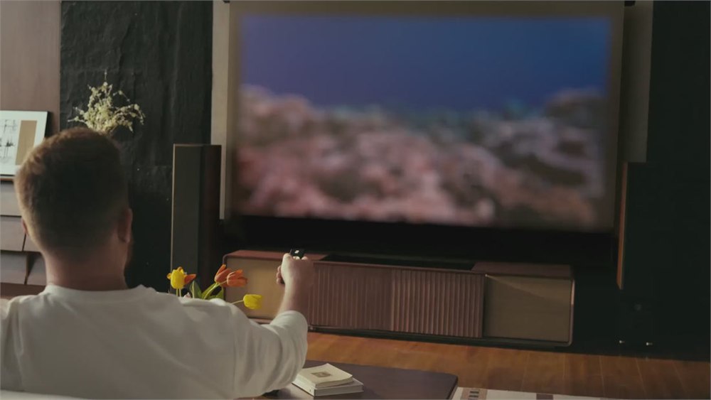 Handheld remote being used with the CINÉST projector media console